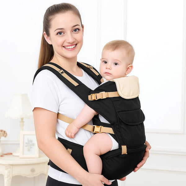 A smiling woman holds a baby in a black baby carrier bag with a hip seat. The carrier features adjustable straps and a soft, padded design, ideal for comfort and support.