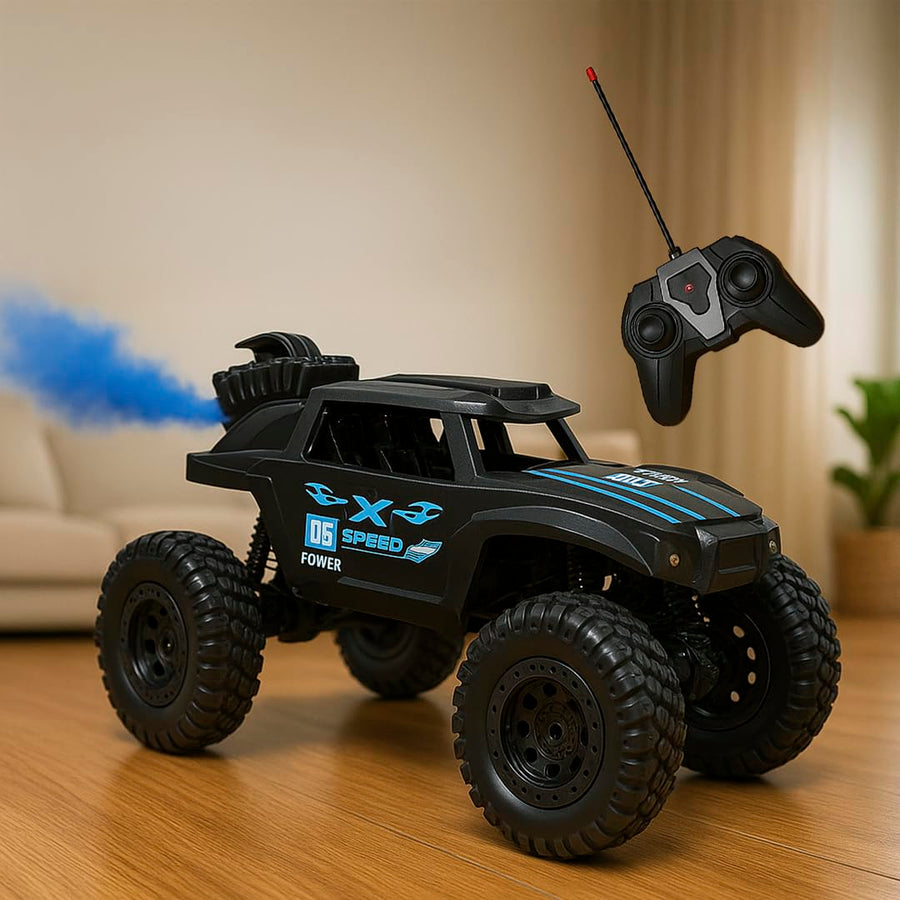 A battery-powered RC rock climber monster car in black with blue accents, featuring large tires and a remote control. The car is positioned on a soft surface with a blurred background, suggesting indoor play.