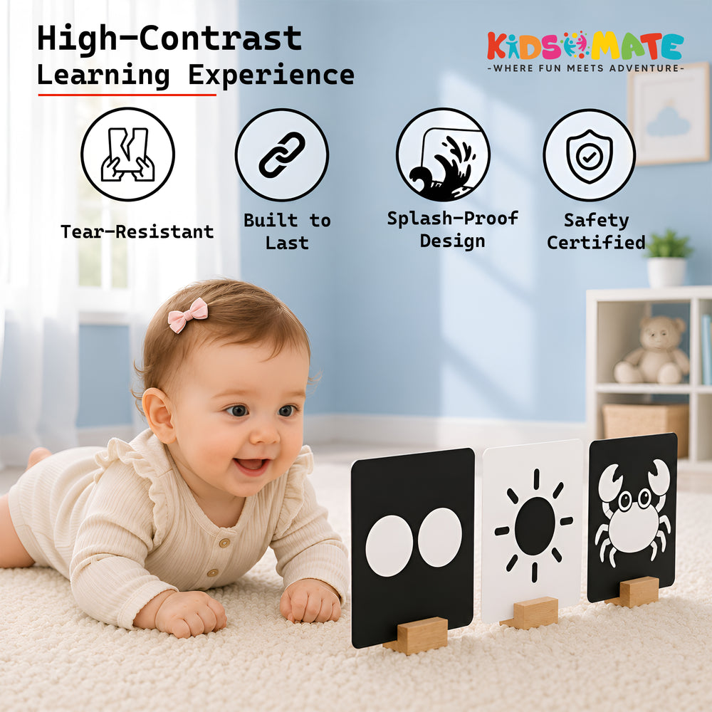A joyful baby sits on a soft surface, engaging with high contrast flash cards. The cards feature bold designs, including circles and a crab, promoting visual learning. Kidsmate branding is visible.
