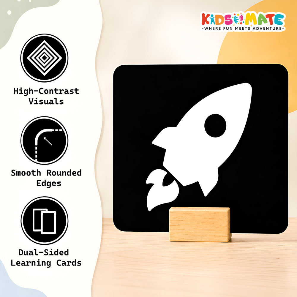 High contrast flash card featuring a white rocket design on a black background. The card has smooth rounded edges and is displayed on a wooden surface, emphasizing its dual-sided learning feature.