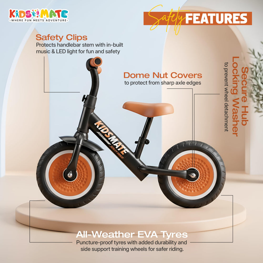 A Kidsmate Jolly Rider Kids Balance Bike featuring a sleek black frame with orange accents, sturdy wheels, and safety clips. The bike is displayed on a light background, highlighting its design and safety features.