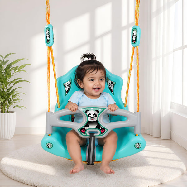 A cheerful child sits in a vibrant turquoise jumbo baby swing with panda designs. The swing features sturdy armrests and bright yellow ropes, set against a bright, airy room with a plant in the background.