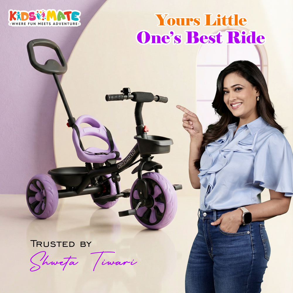 A vibrant Kidsmate Junior Tricycle designed for kids, featuring a comfortable seat and parental control handle. A smiling woman stands beside it, showcasing the fun and adventure it offers.