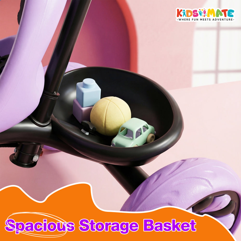 A close-up view of a tricycle's spacious storage basket, featuring colorful toys like a yellow ball and small cars, set against a playful background. The Kidsmate logo is visible in the corner.