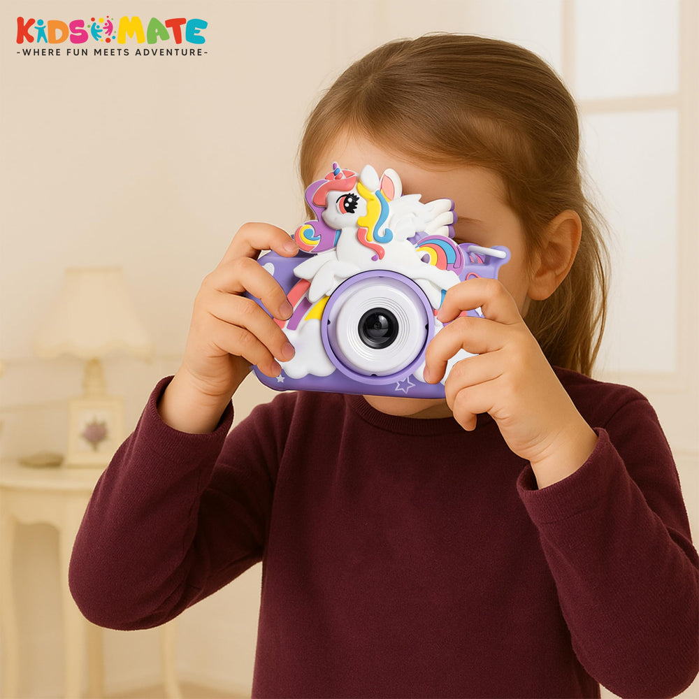 A young child holding a colorful mini digital camera designed with a unicorn theme. The camera features a 2-inch HD screen and is set against a bright, cheerful background.