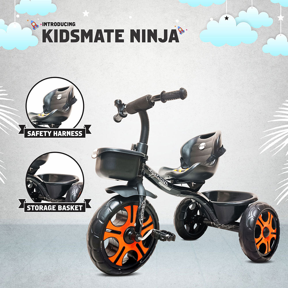 A durable black tricycle for kids featuring a safety harness and a storage basket. The wheels are highlighted in orange, adding a playful touch to the design. The background includes clouds and playful graphics.