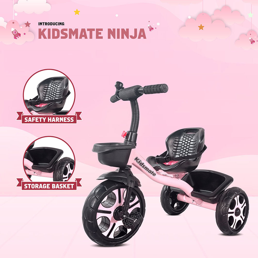 A pink Kidsmate Ninja tricycle designed for kids, featuring a safety harness and a storage basket. The background is playful with clouds and a light color scheme, enhancing the cheerful vibe.