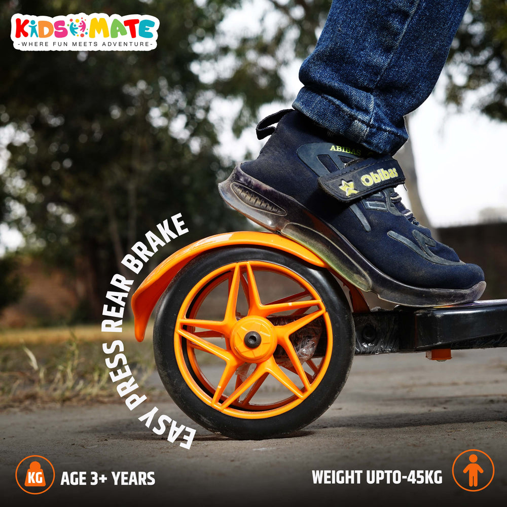 A close-up of a Kidsmate kick scooter's rear wheel featuring a bright orange brake. The scooter is set against a grassy background, showcasing its sturdy design and vibrant colors.