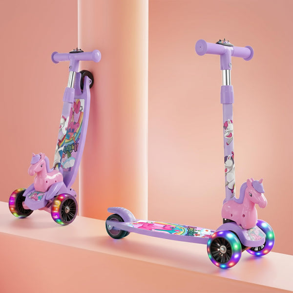A vibrant purple kick scooter designed for kids, featuring LED wheels and a playful unicorn design on the deck. The scooter has a cute unicorn handle and is positioned against a soft pink backdrop.